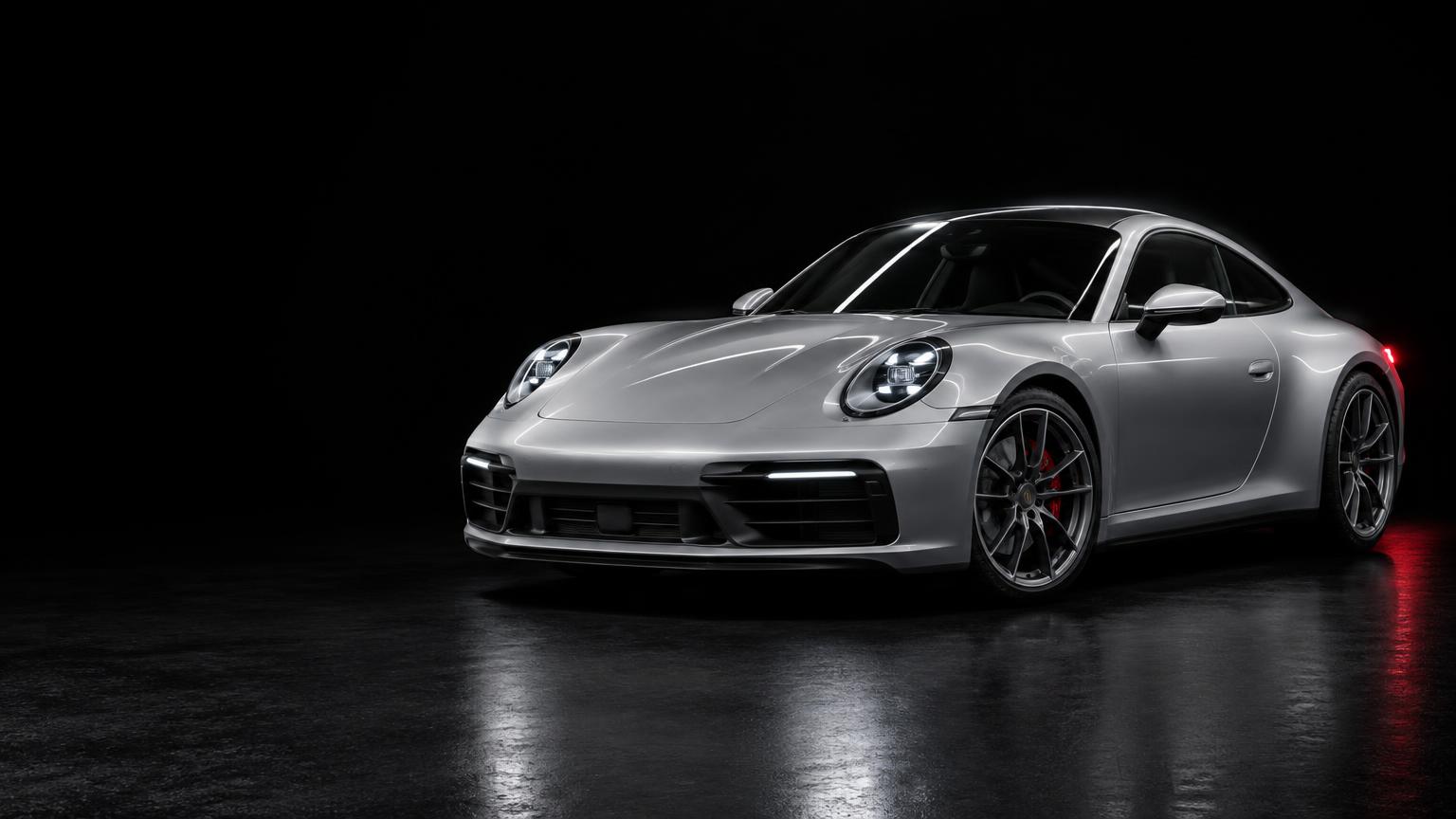 Silver sports coupe in an automotive studio